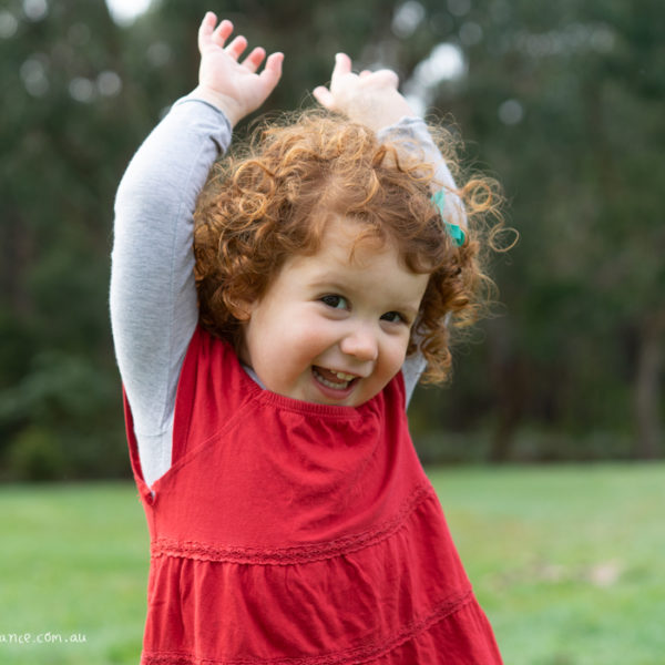 Young girl explores outside for family portraits at Melbourne family portrait studio
