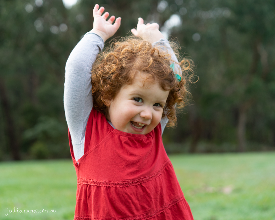 Young girl explores outside for family portraits at Melbourne family portrait studio