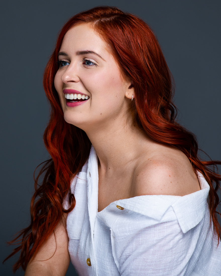 Fine art portrait of redhead woman laughing in Melbourne portrait studio