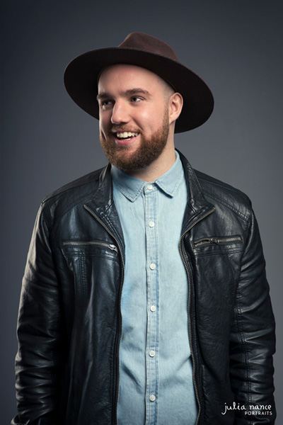 Smiling man wears a hat in Melbourne portrait studio.